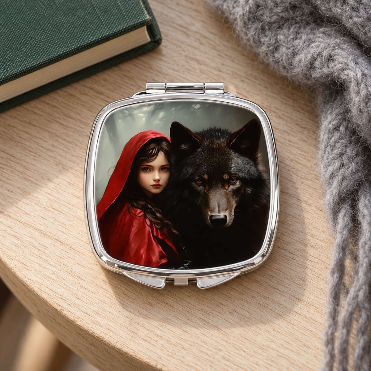 A compact mirror with a photo of a woman in a red hooded cloak and a wolf on the reflective surface.