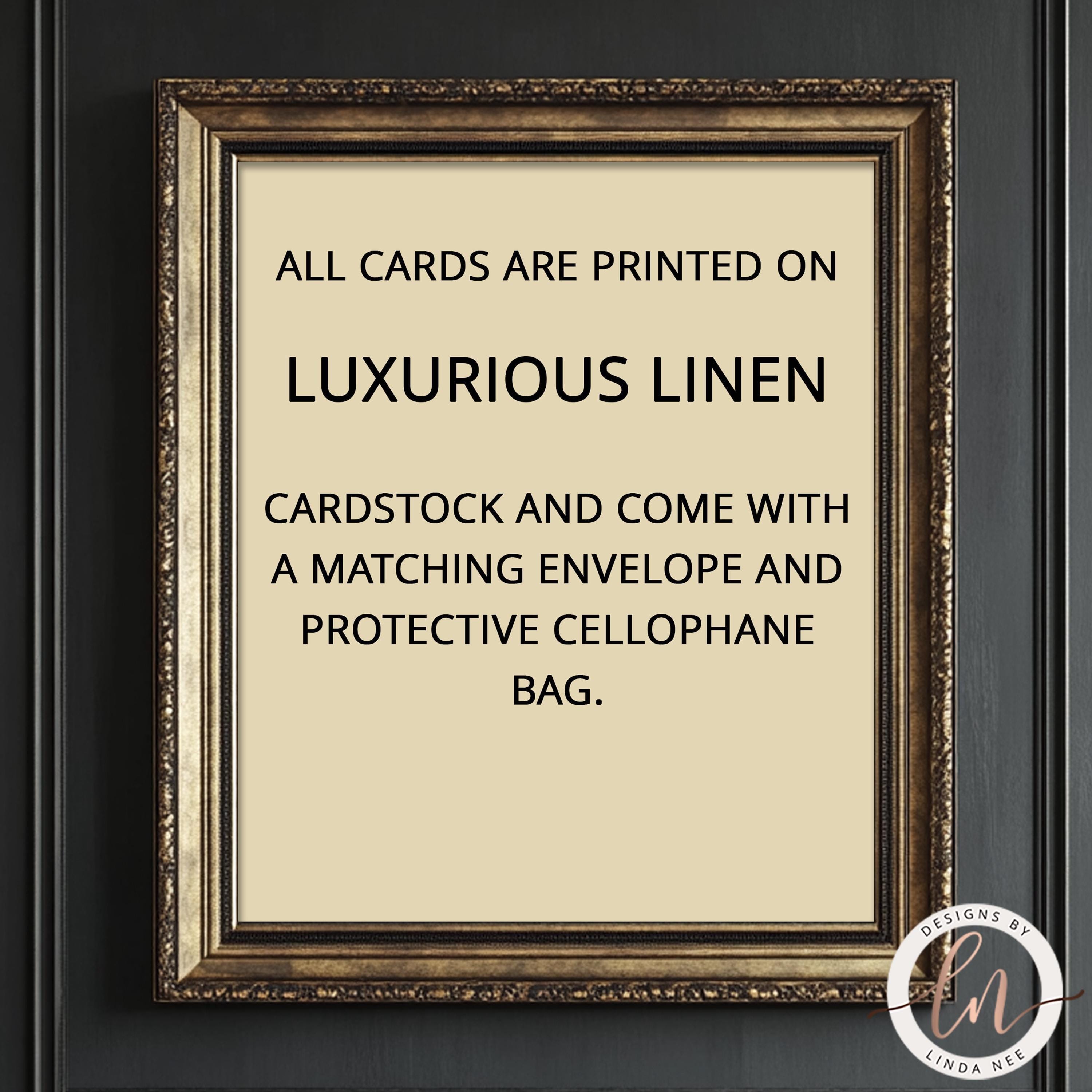 a framed sign with text stating that all cards are printed on luxurious linen and that the cards come with a matching envelope and protective cellulose bag.