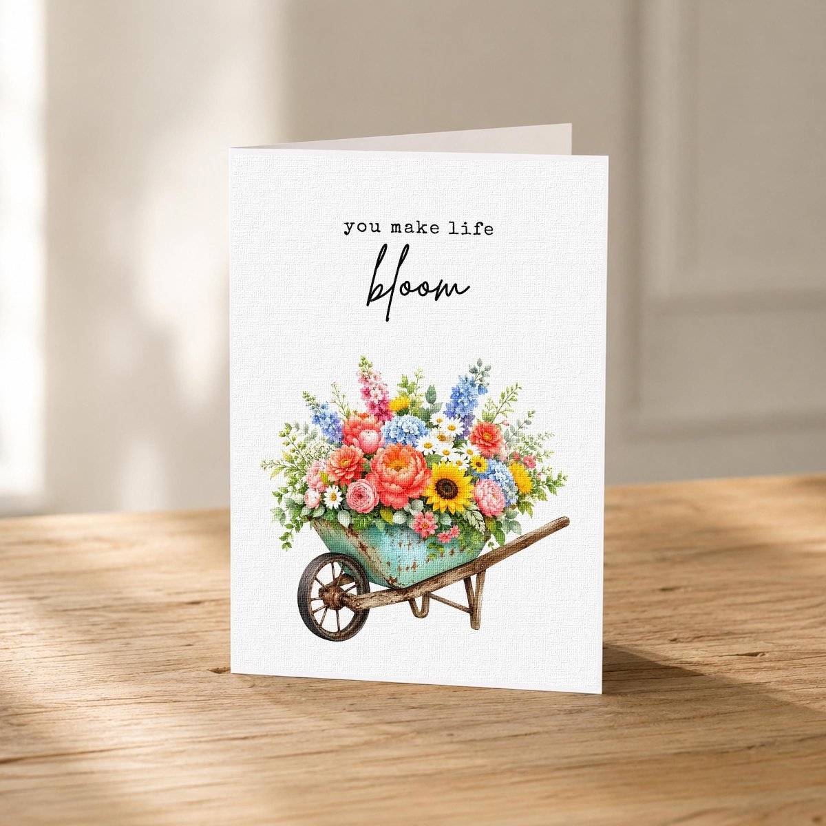 Close-up of the You Make Life Bloom Appreciation Card showing the floral wheelbarrow artwork.