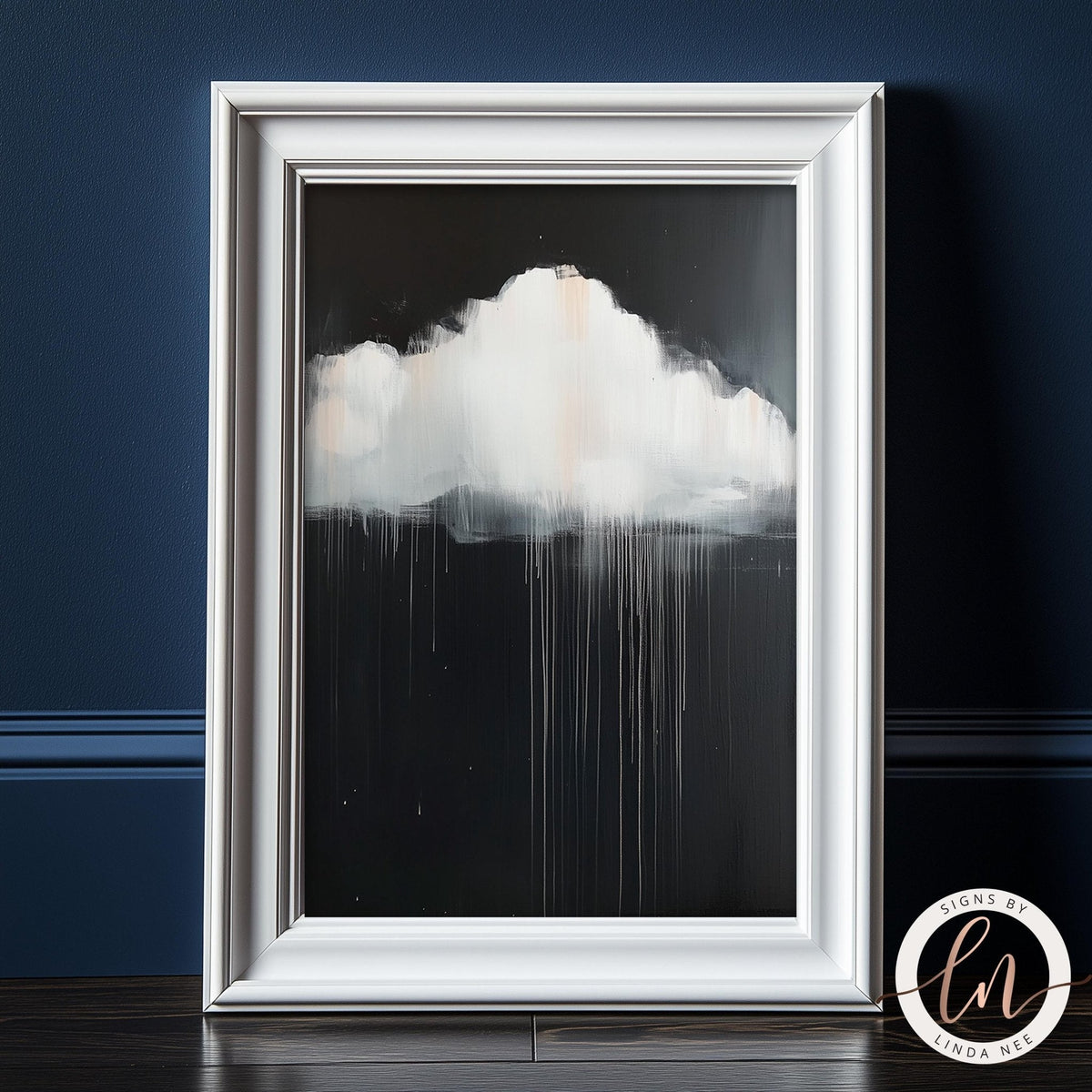 a framed artwork depicting a white cloud with a black background, creating a striking contrast.