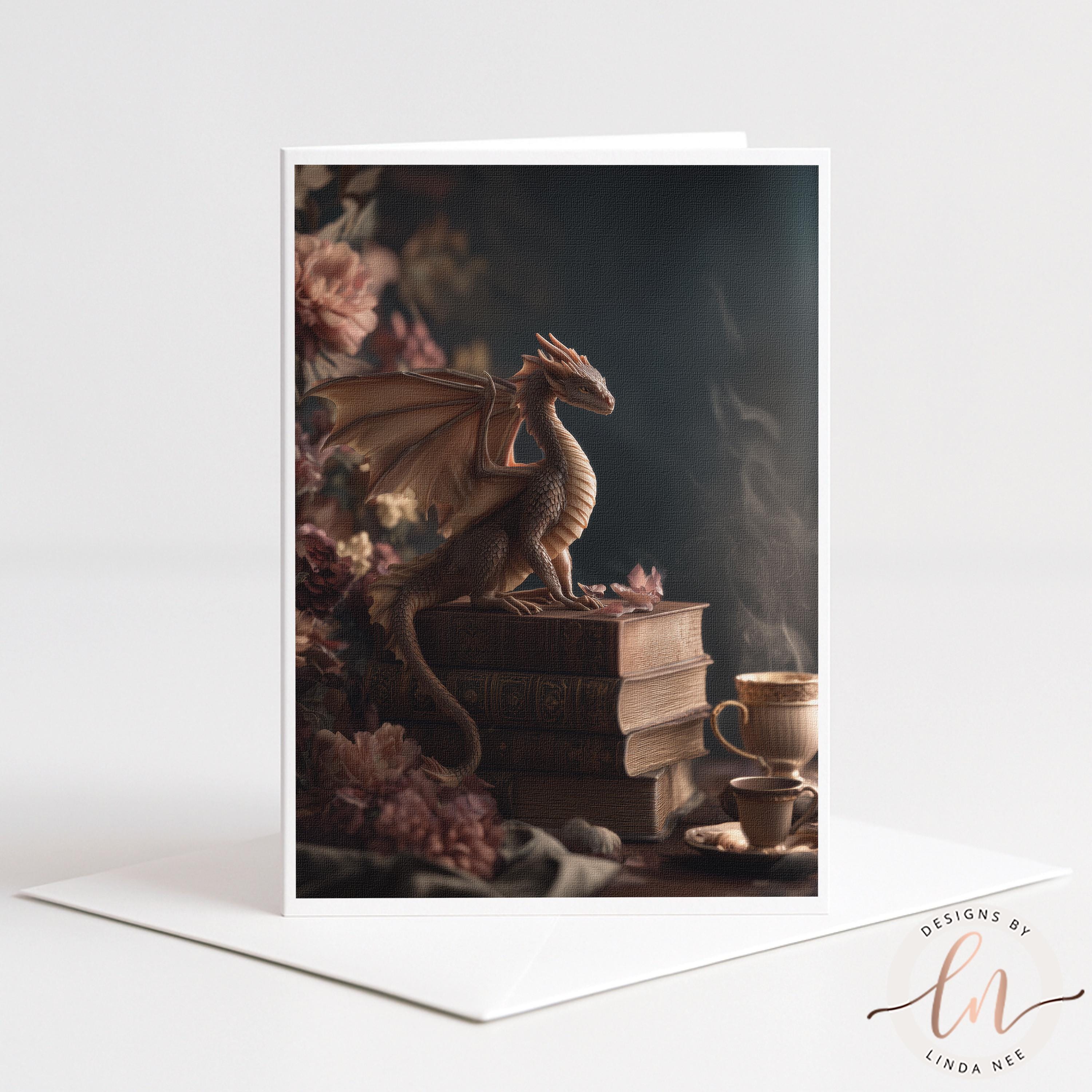 A dragon figurine perched on a stack of books, with a cup of tea nearby, set against a backdrop of pink flowers.