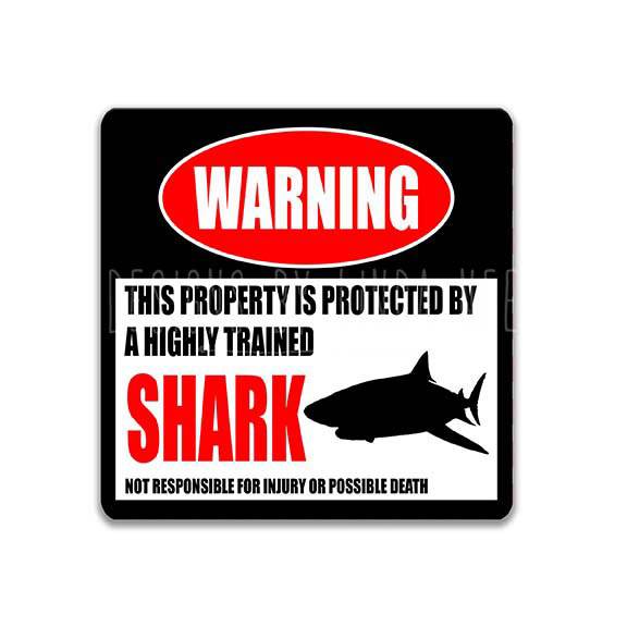 Square shark warning metal sign, black background with red WARNING banner and shark silhouette