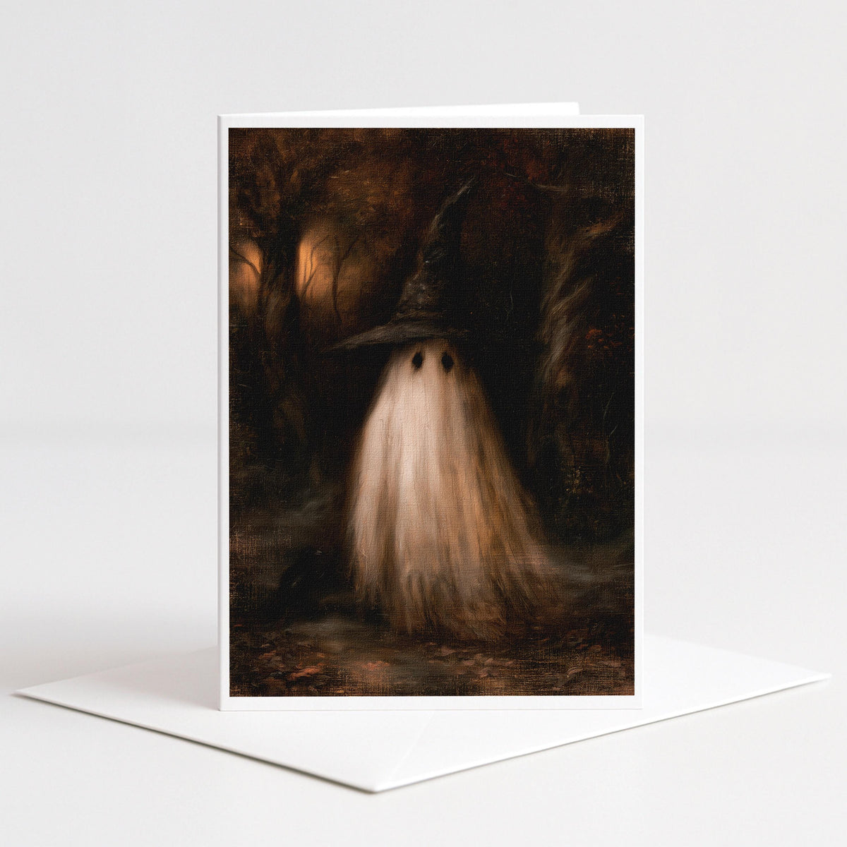 Ghost wearing an oversized witch hat in dark woods on a 5x7 blank note card by Designs by Linda Nee