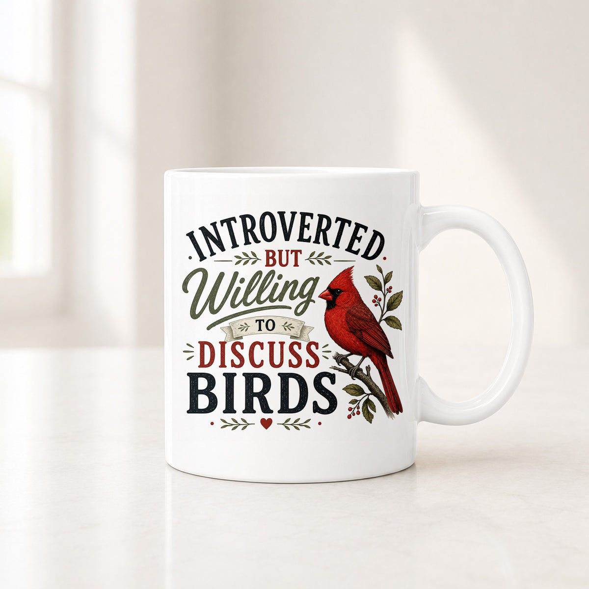 11 oz white Introverted But Willing to Discuss Birds mug with charcoal, red and olive lettering beside a cardinal
