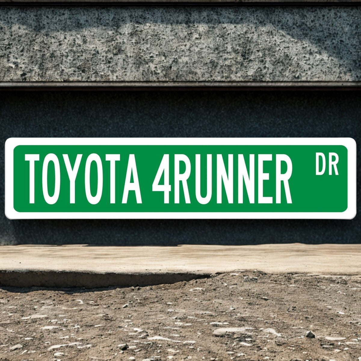 Green street sign with 'TOYOTA 4RUNNER DR' on a dark background