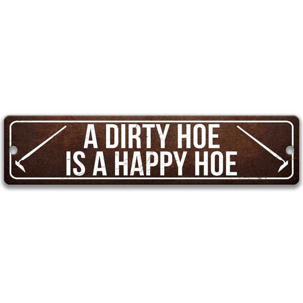 A sign with the text "A DIRTY HOE IS A HAPPY HOE" printed on it.