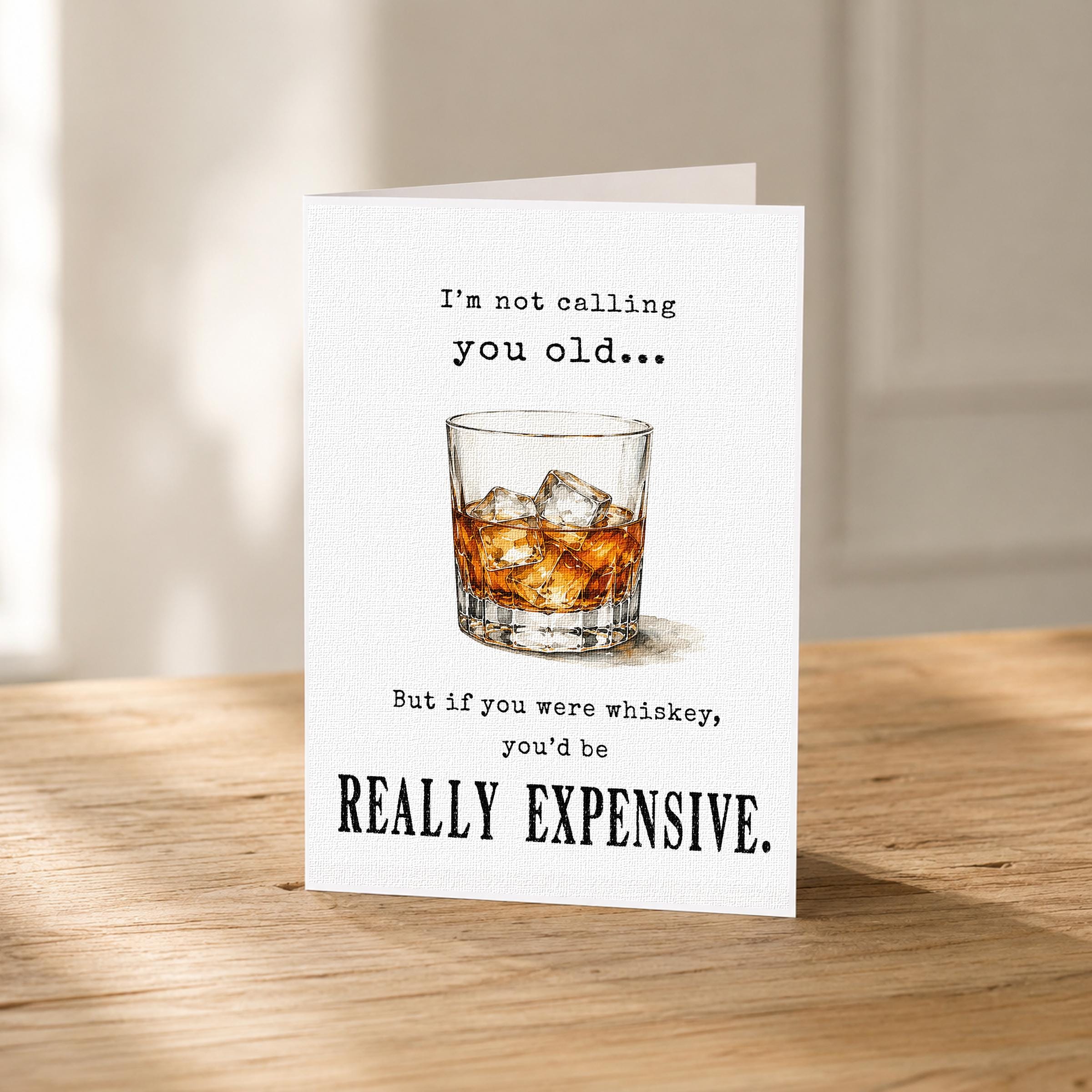 a humorous text card with a glass of whiskey and ice cubes, accompanied by a playful message about age and whiskey consumption.
