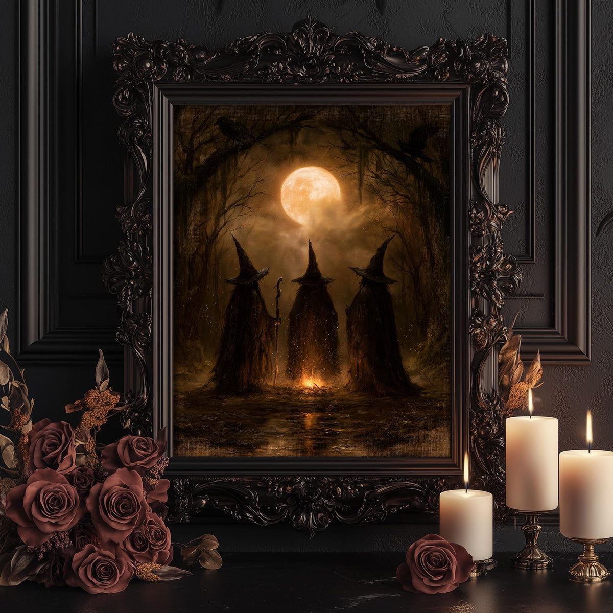 Three witches print shown framed for display beside lit candles and dark roses