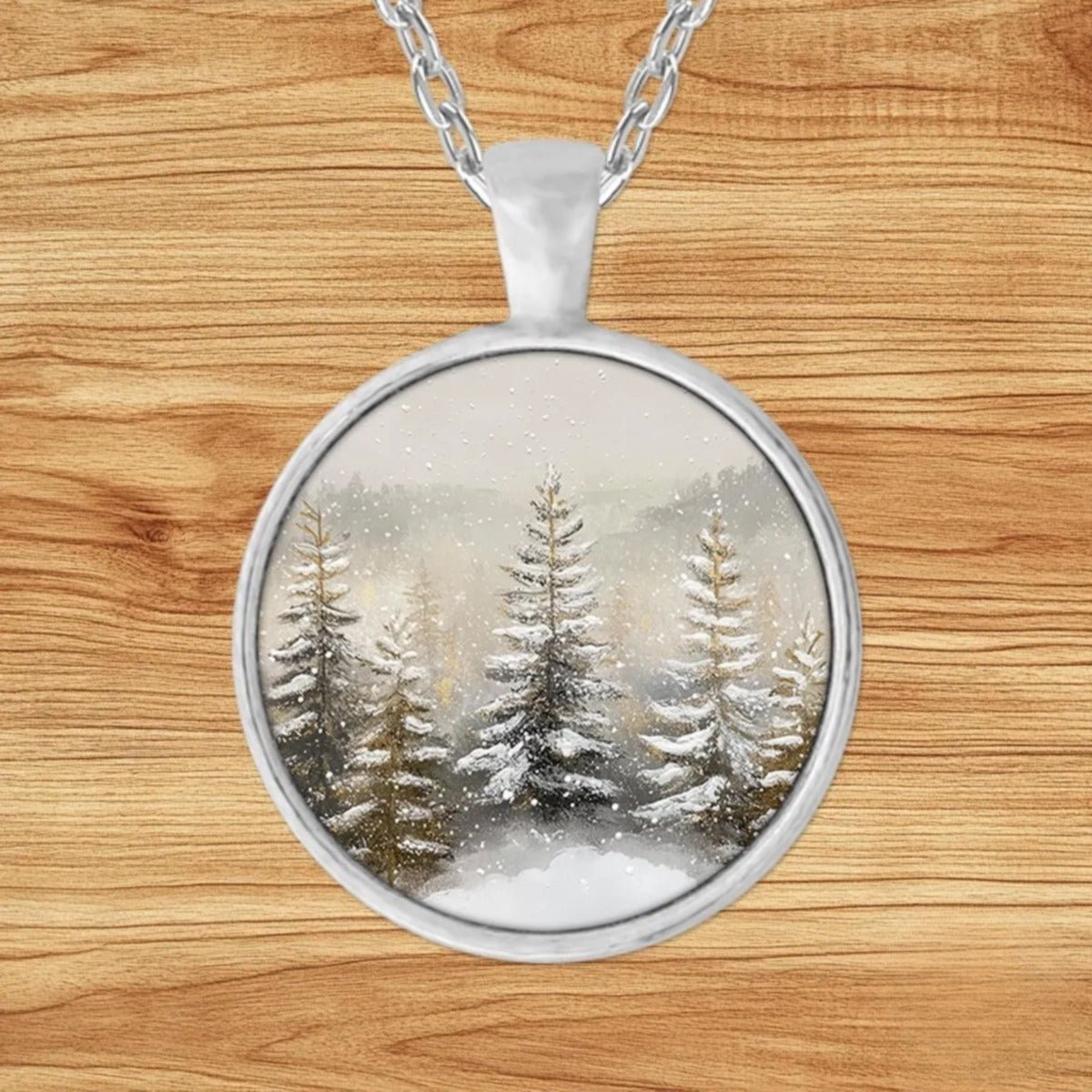 Round silver charm pendant necklace featuring a hushed pine forest blanketed in freshly fallen snow