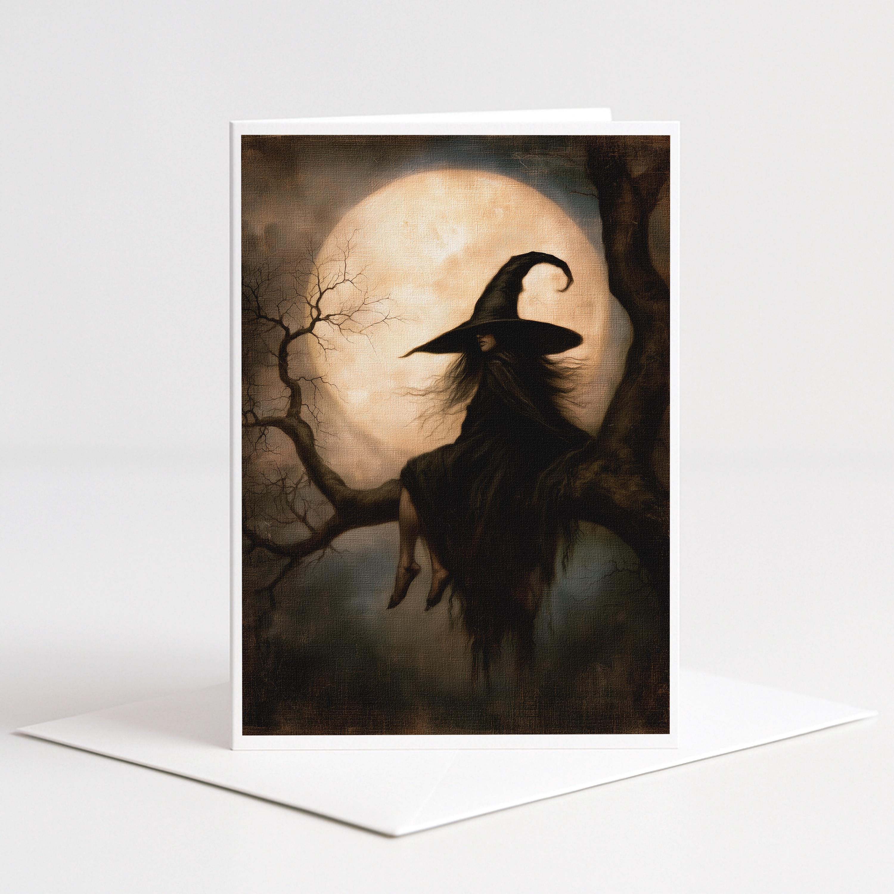 5x7 gothic Halloween greeting card featuring a mysterious black-clad witch perched on twisted bare tree branches in front of a large glowing full moon, rendered in a moody vintage painterly style with black, brown, cream, and muted gray-green tones.