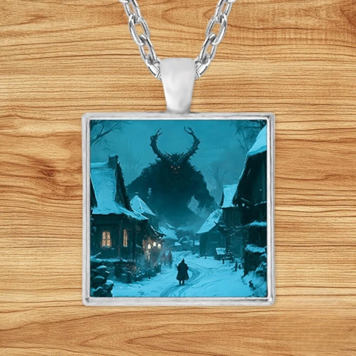 Square silver charm pendant necklace featuring the horned Krampus looming over a snow-covered European village beneath a moonlit sky
