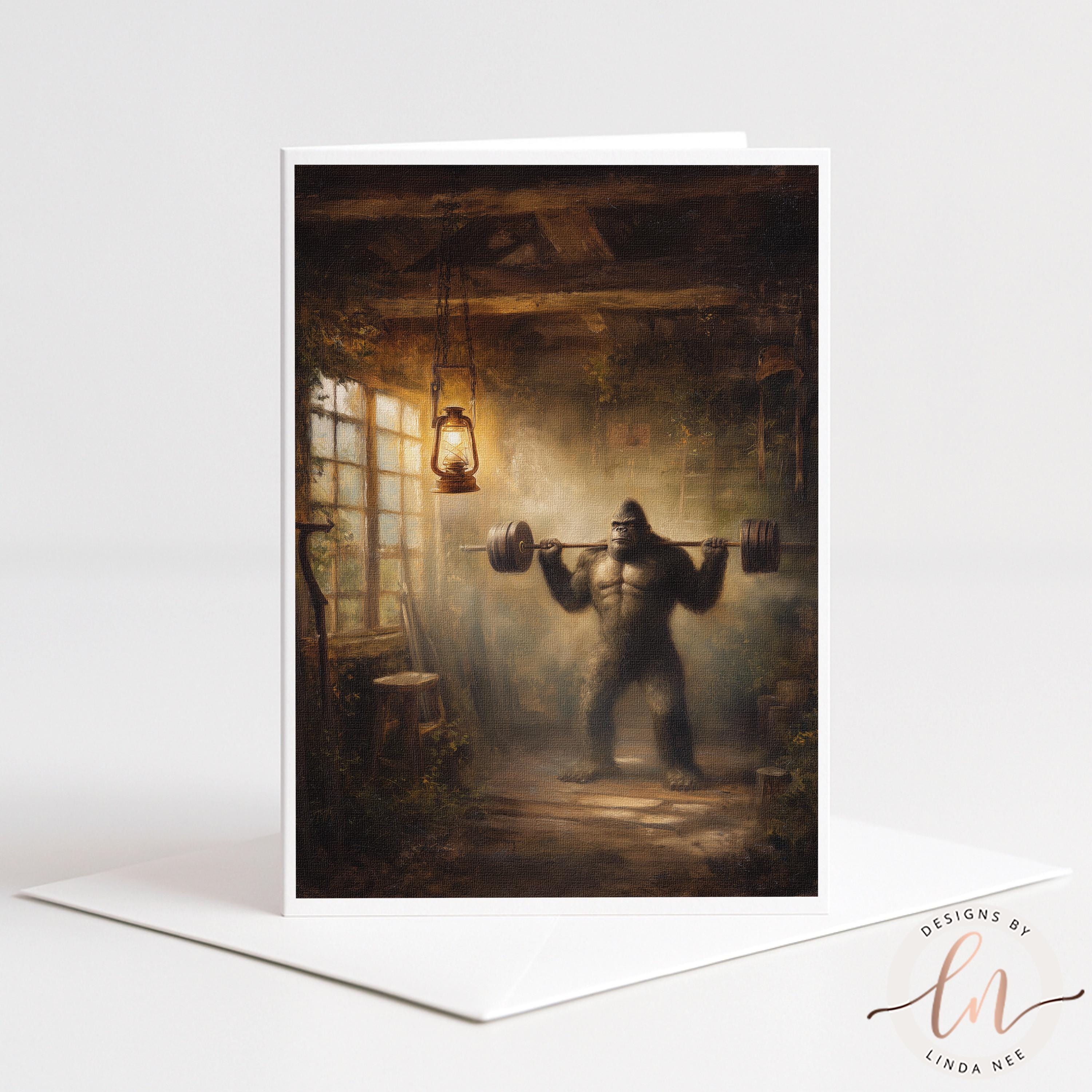 Greeting card by Linda Nee featuring Bigfoot squatting a heavily loaded barbell inside a rustic cabin gym with warm lantern light, wood beams, smoky shadows, and a funny leg day fitness theme.