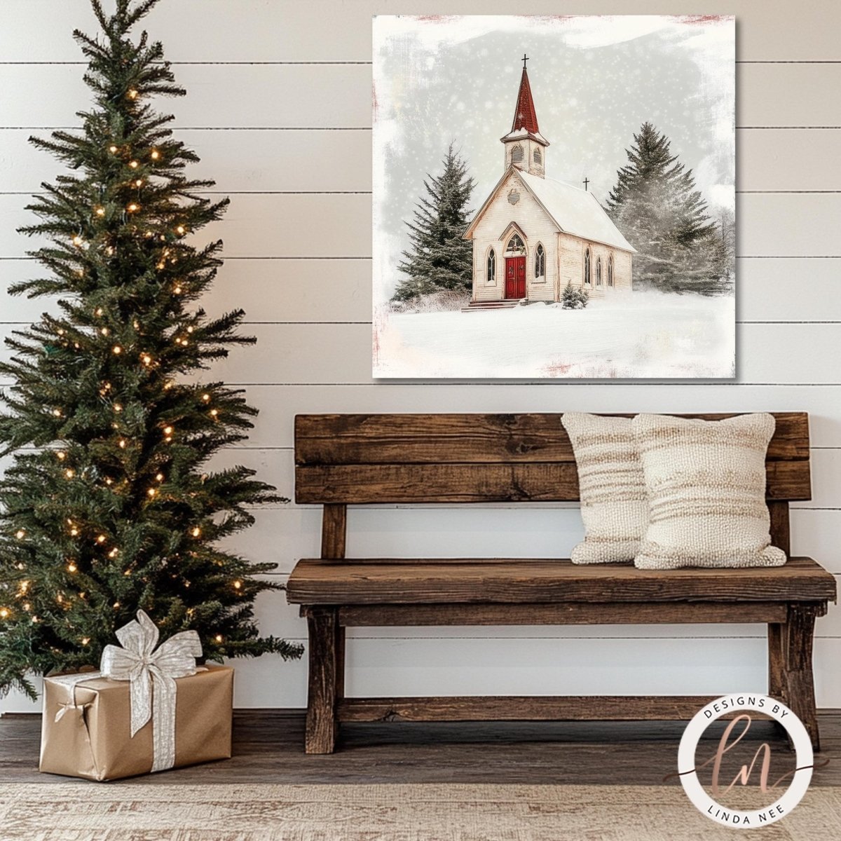 Snowy church artwork shown on a shiplap wall above a bench with pillows