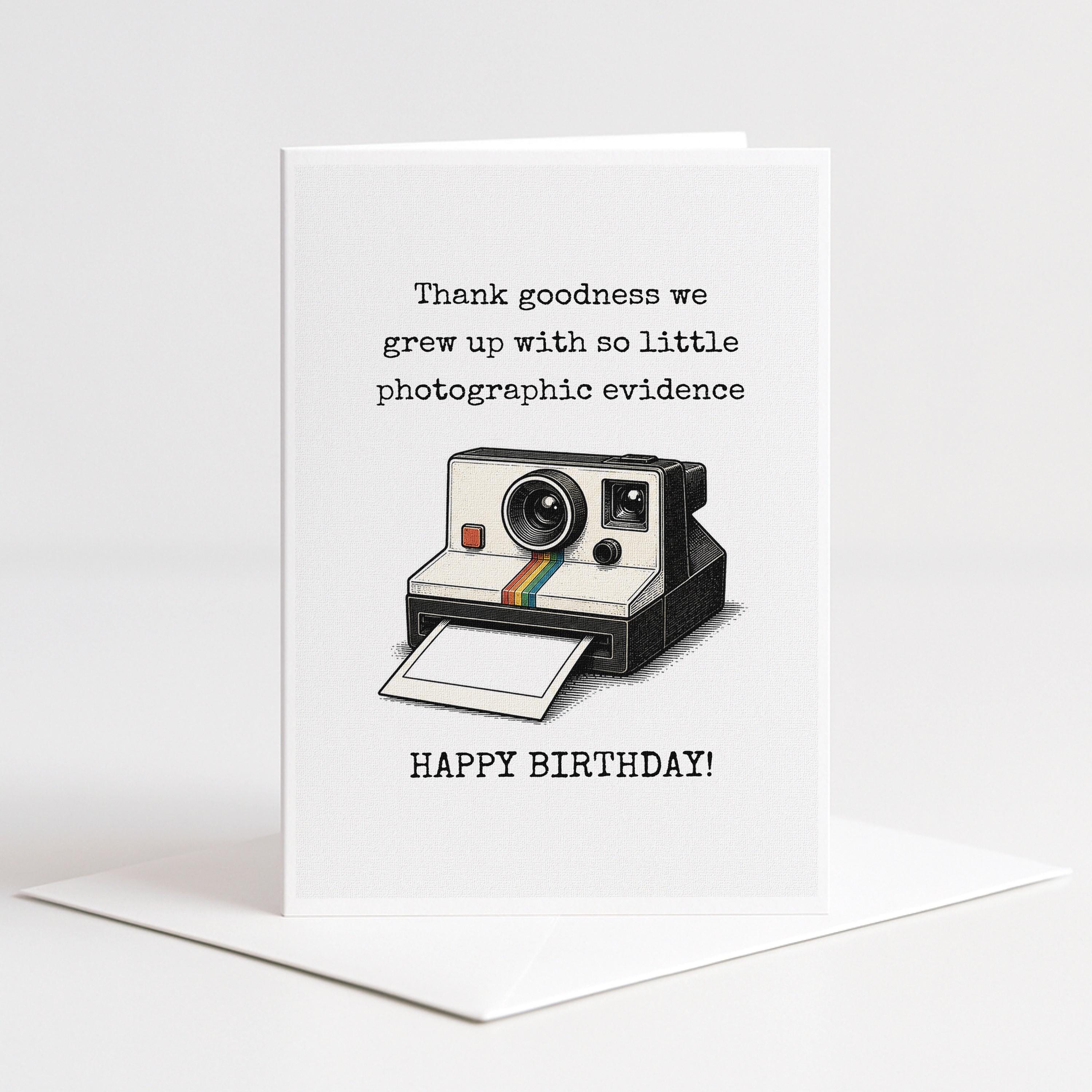 A greeting card with a Polaroid camera and the text "Thank goodness we grew up with so little photographic evidence" and "Happy birthday!"