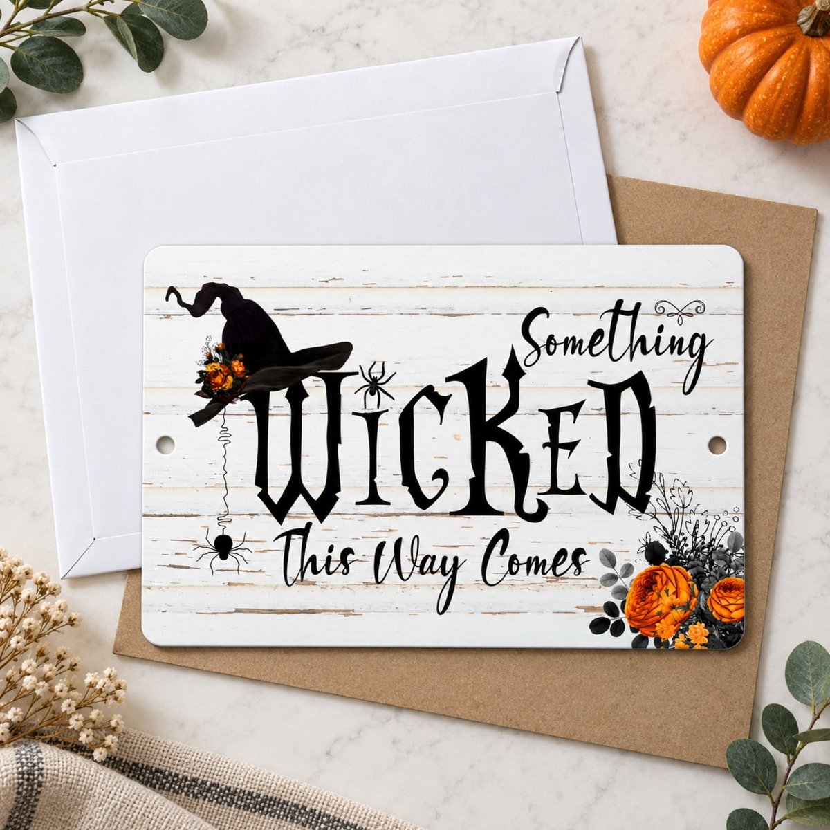 Something Wicked This Way Comes witch hat sign styled with a pumpkin and fall decor