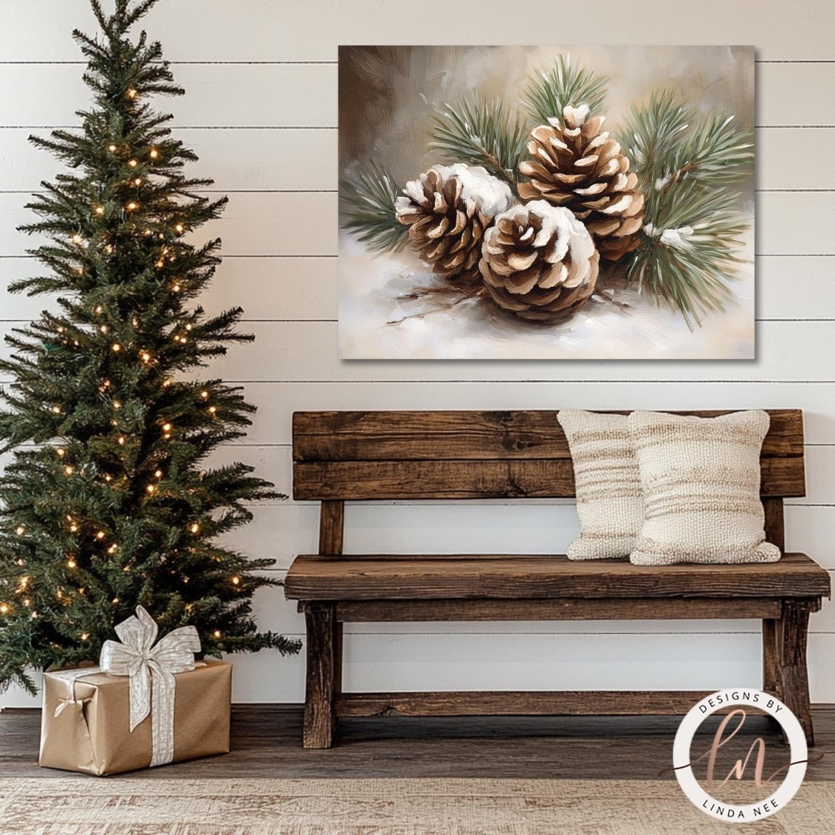 Pine cone decor wall art shown above a wooden bench beside a lit Christmas tree
