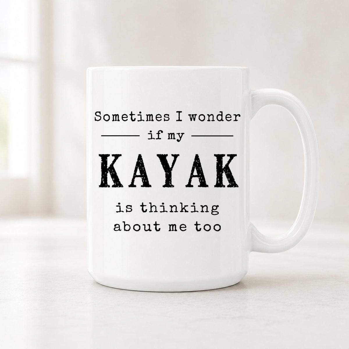 Sometimes I Wonder If My Kayak Is Thinking About Me Too mug, white ceramic with the quote in bold black type