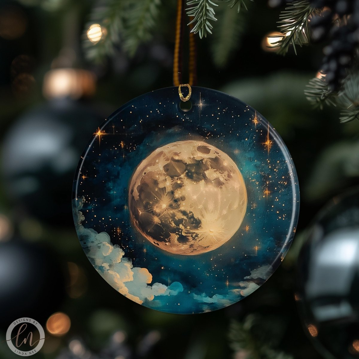 A round ornament with a moon and stars design hangs from a tree branch, surrounded by other ornaments.