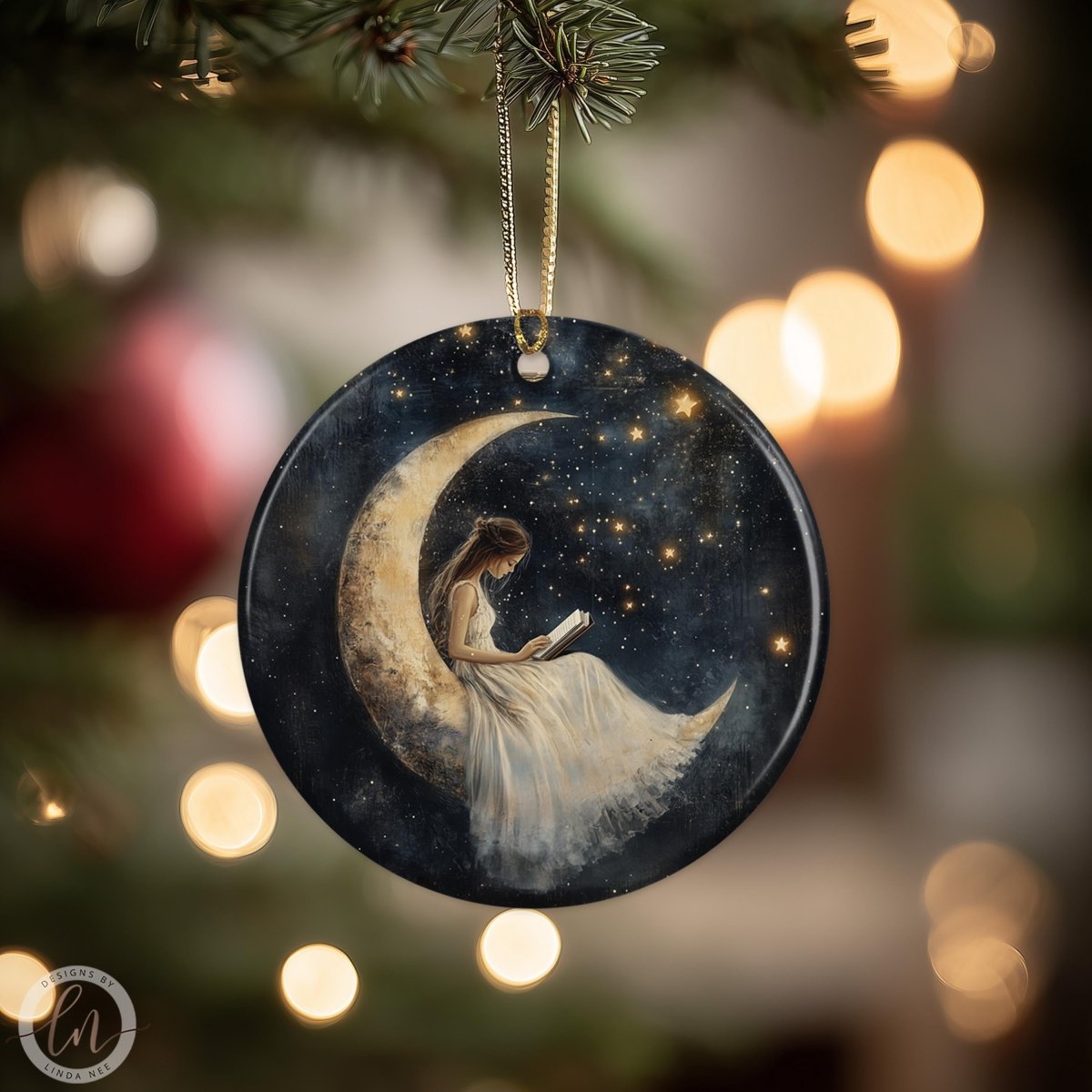 A round ornament featuring a woman reading a book while sitting on a crescent moon, with a starry night sky background.