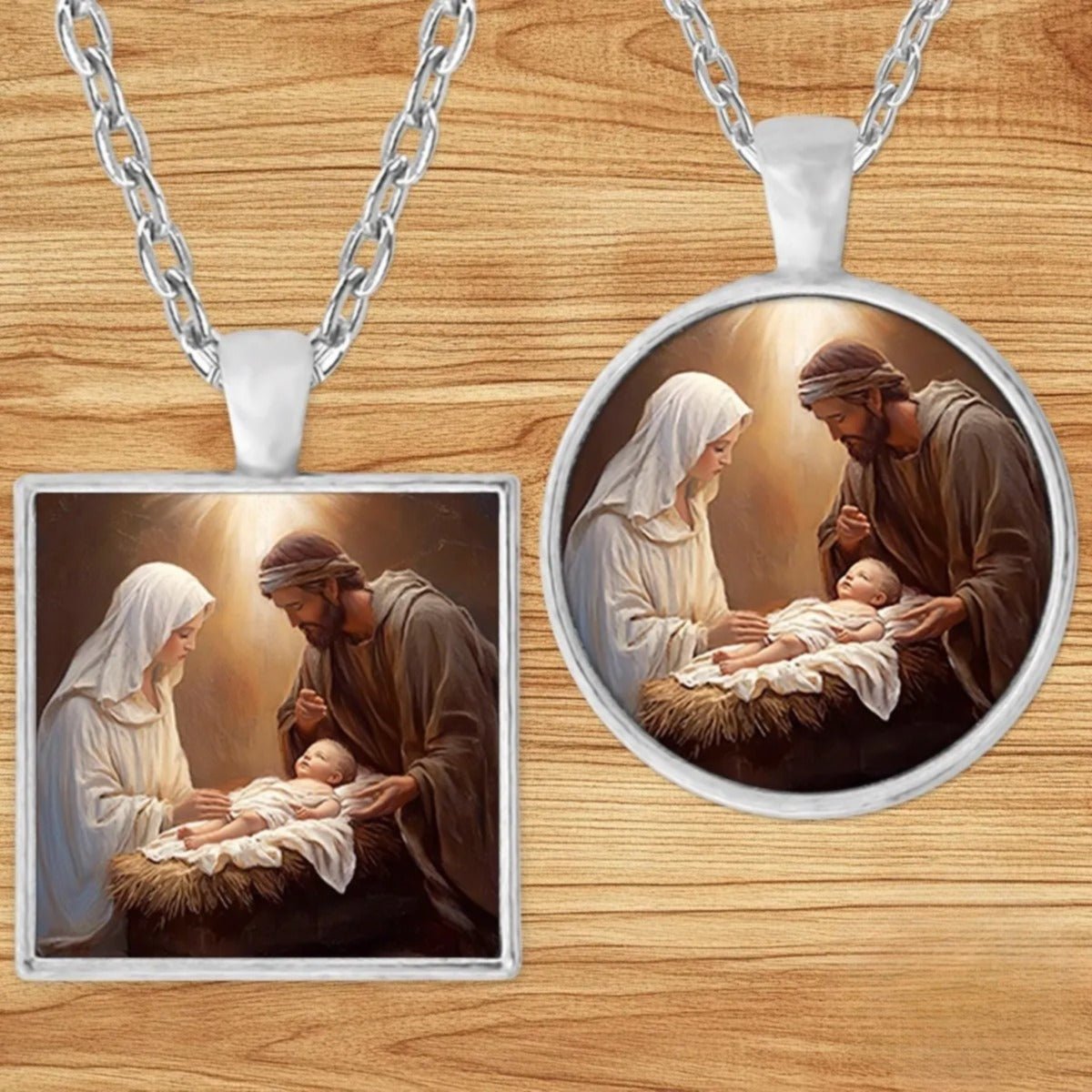 Holy Family Nativity pendant necklace shown in round and square silver charm styles on a wood background