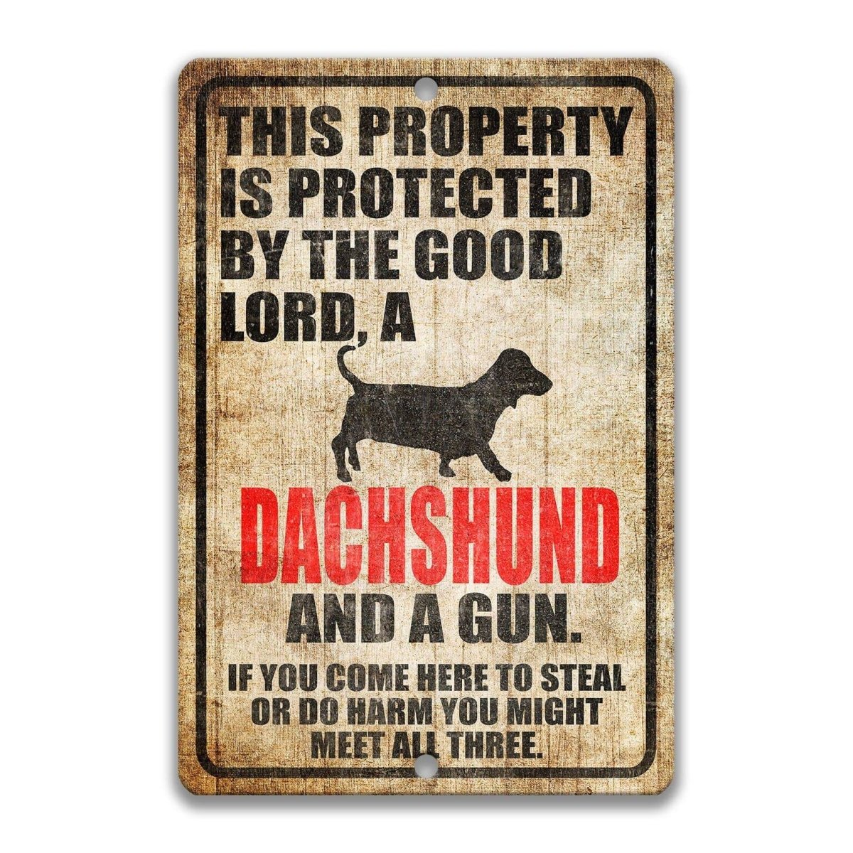 The image is a sign that reads "This property is protected by the good Lord, a Dachshund and a gun. If you come here to steal or do harm, you might meet all three."