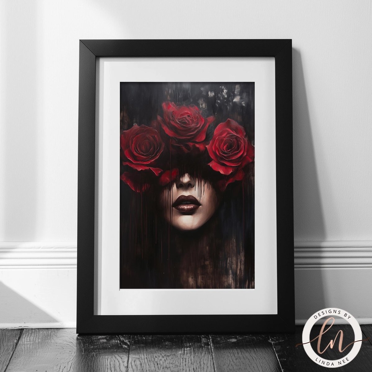 The image is a framed artwork depicting a woman's face with three red roses covering her eyes, creating a striking and dramatic visual effect.