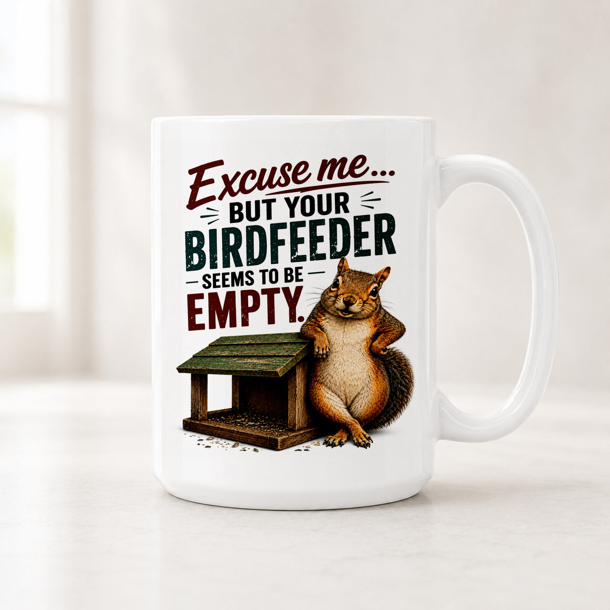 15 oz squirrel mug with a smug squirrel leaning on an empty green-roofed bird feeder under Excuse Me in red script