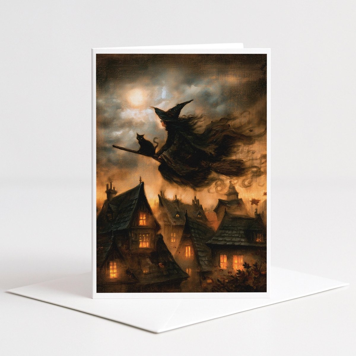 Witch and black cat flying over a glowing old village at night, Halloween note card art