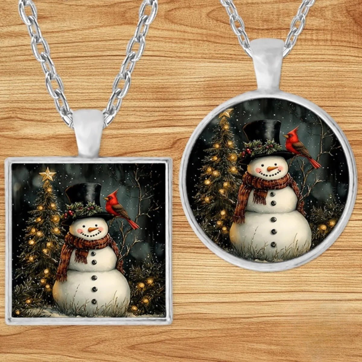 Snowman & Cardinal Christmas pendant necklace shown in round and square silver charm styles on a wood background