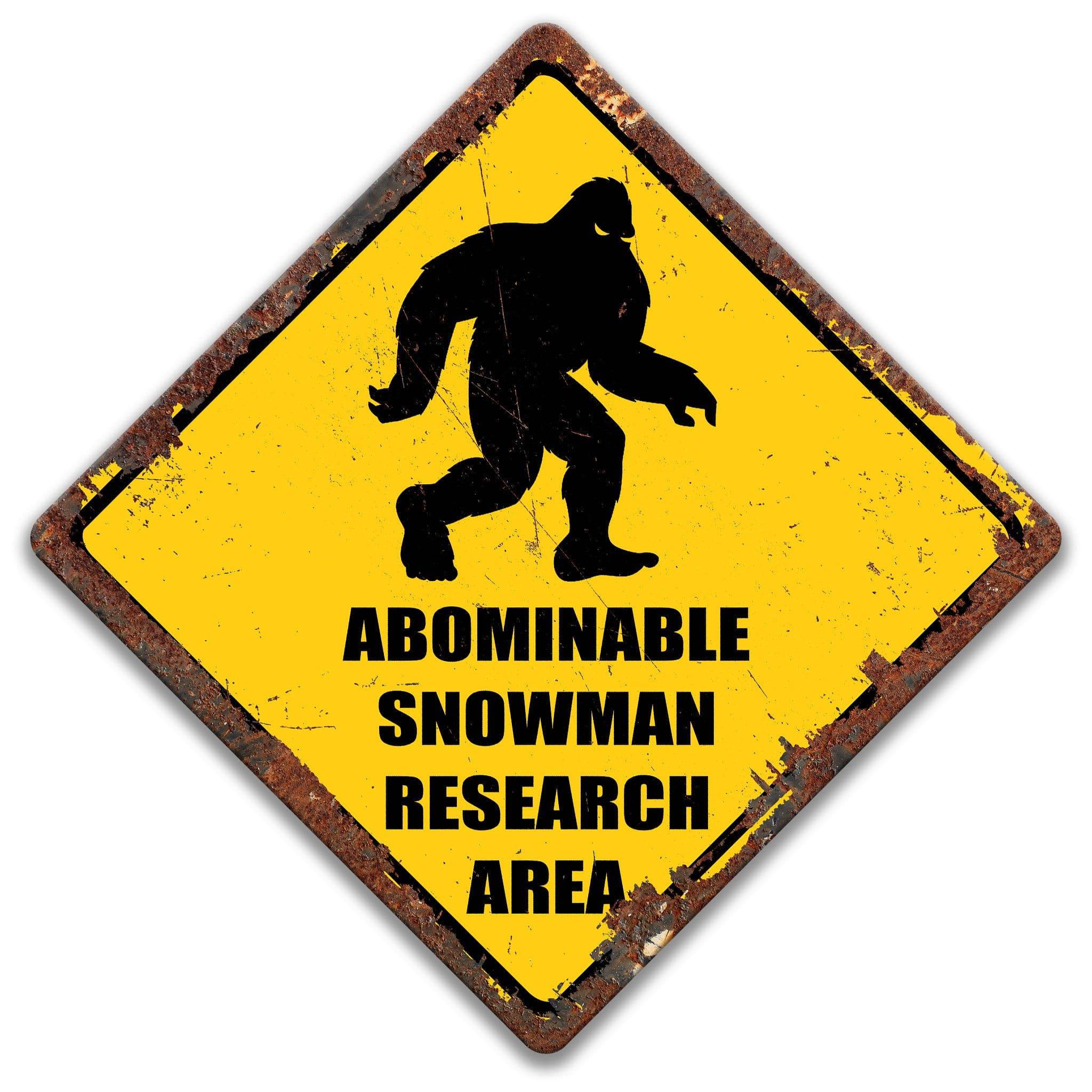 a sign with a silhouette of a large, furry creature, likely a Sasquatch, and the text "ABOMINABLE SNOWMAN RESEARCH AREA" written below it.