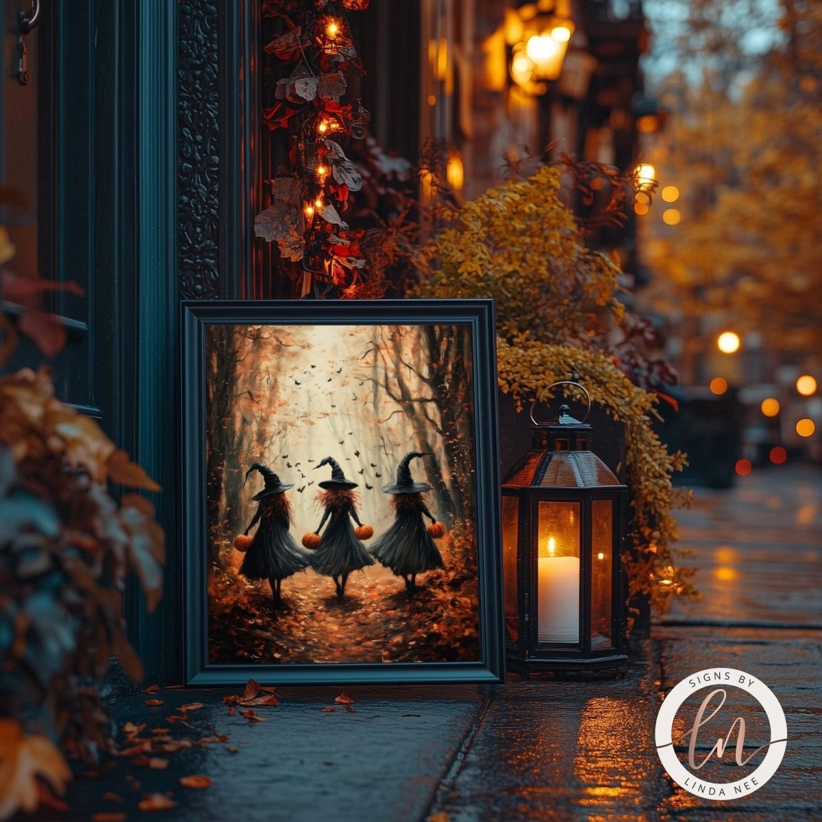 Three witches walking home art print shown with a lantern and autumn leaves