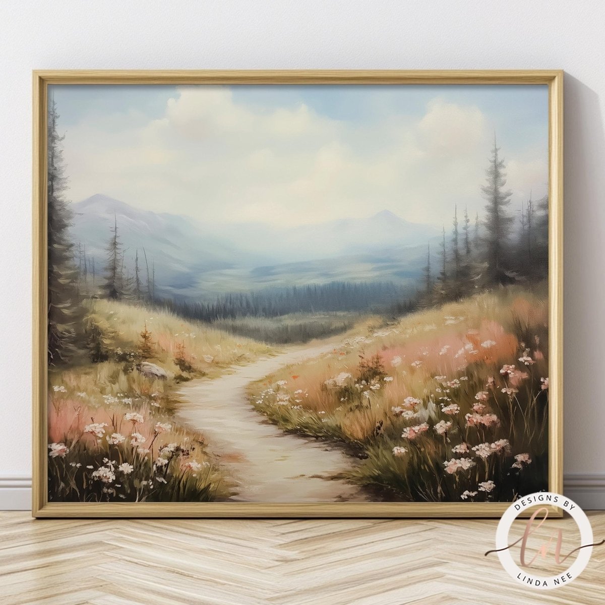 A framed landscape painting depicting a winding path through a mountainous, forested area with wildflowers.