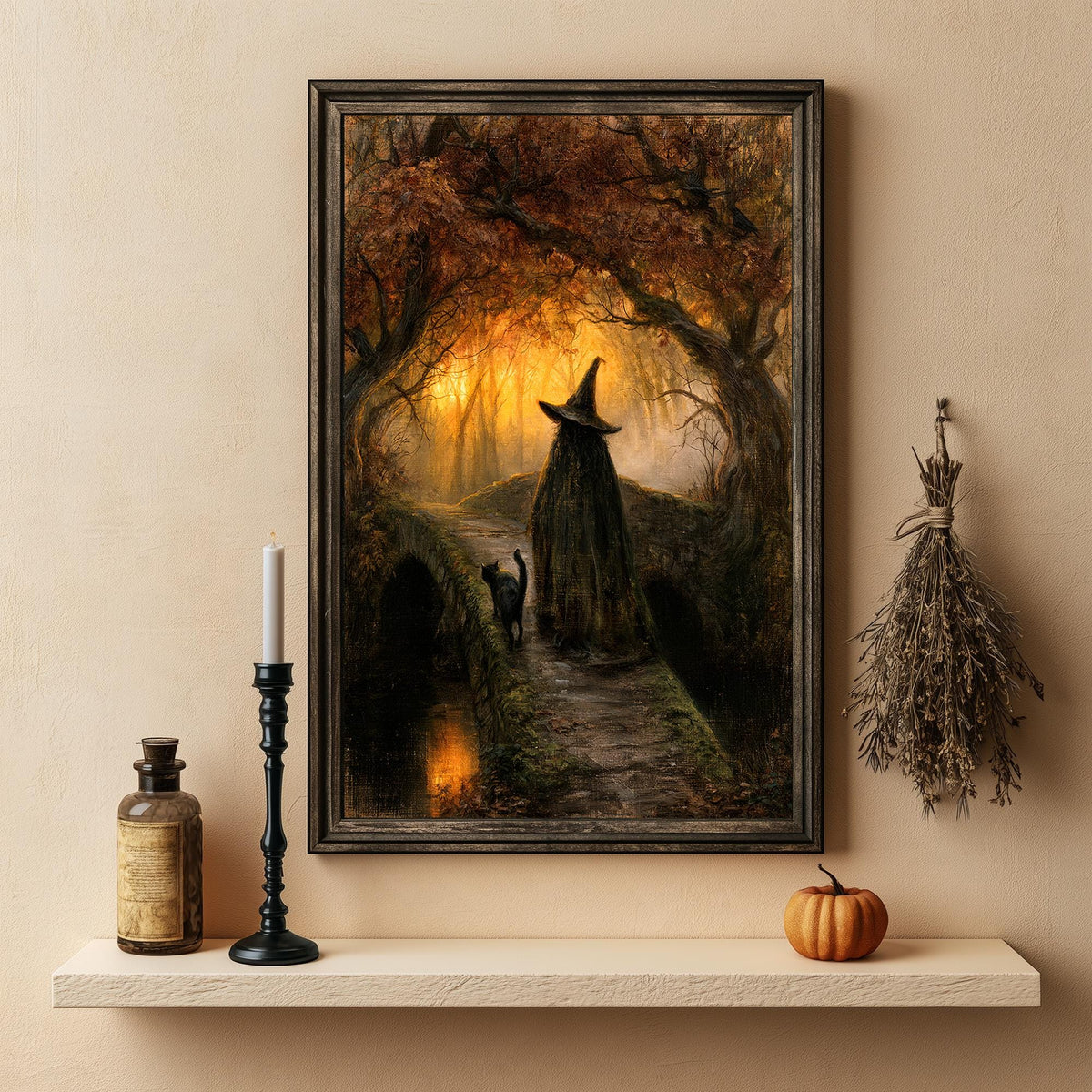 Gothic Halloween print above a shelf holding a small pumpkin and a lit candle