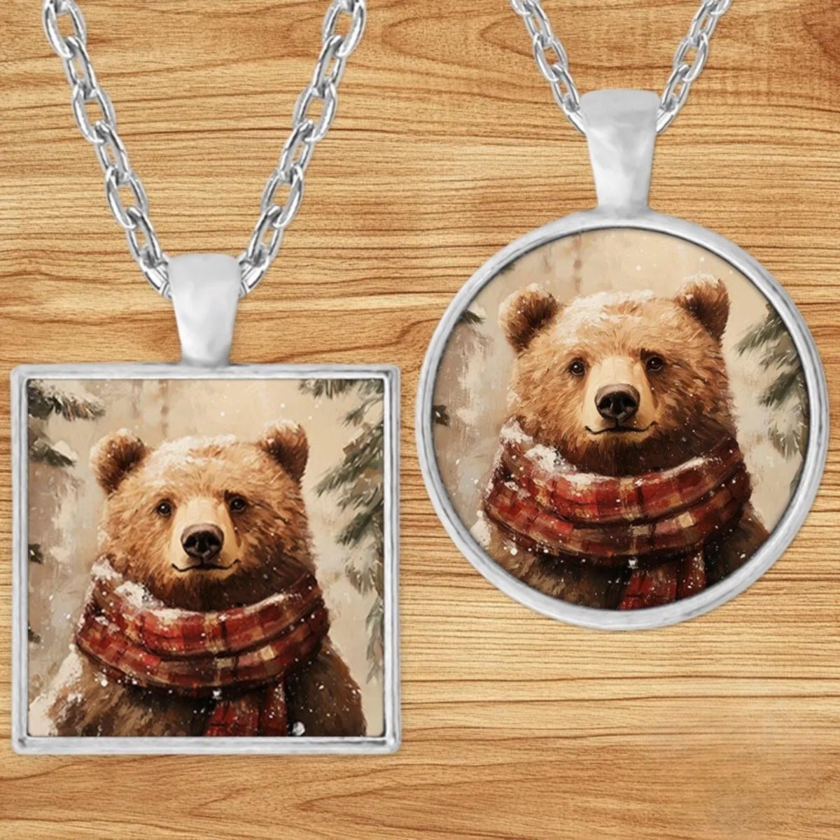 Bear in a Plaid Scarf pendant necklace shown in round and square silver charm styles on a wood background