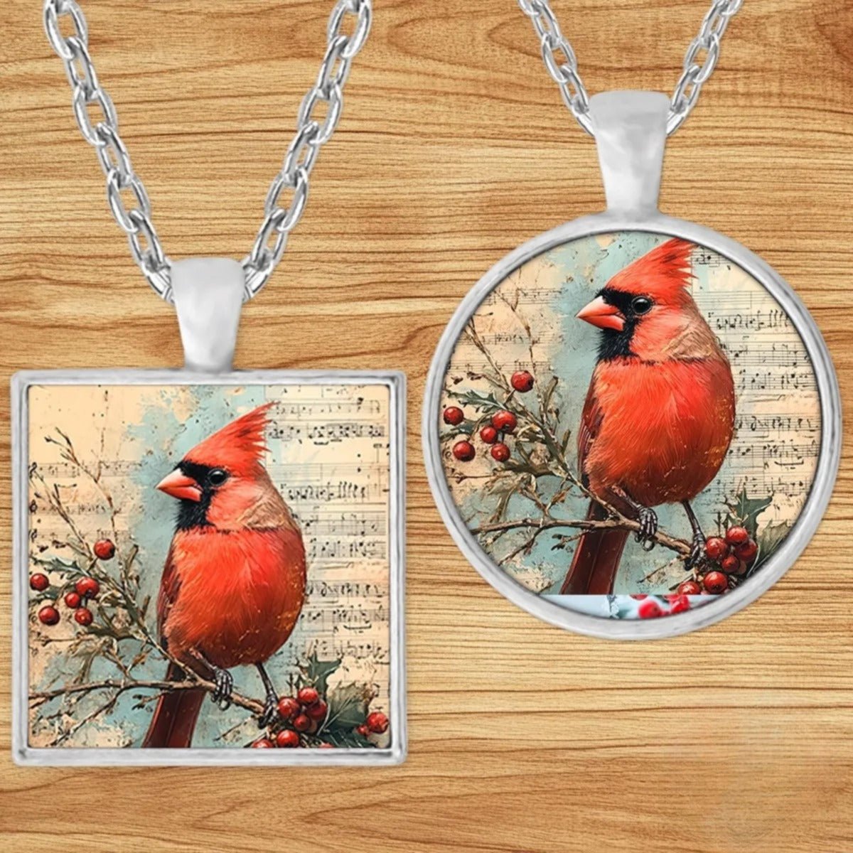 Cardinal Sheet Music pendant necklace shown in round and square silver charm styles on a wood background