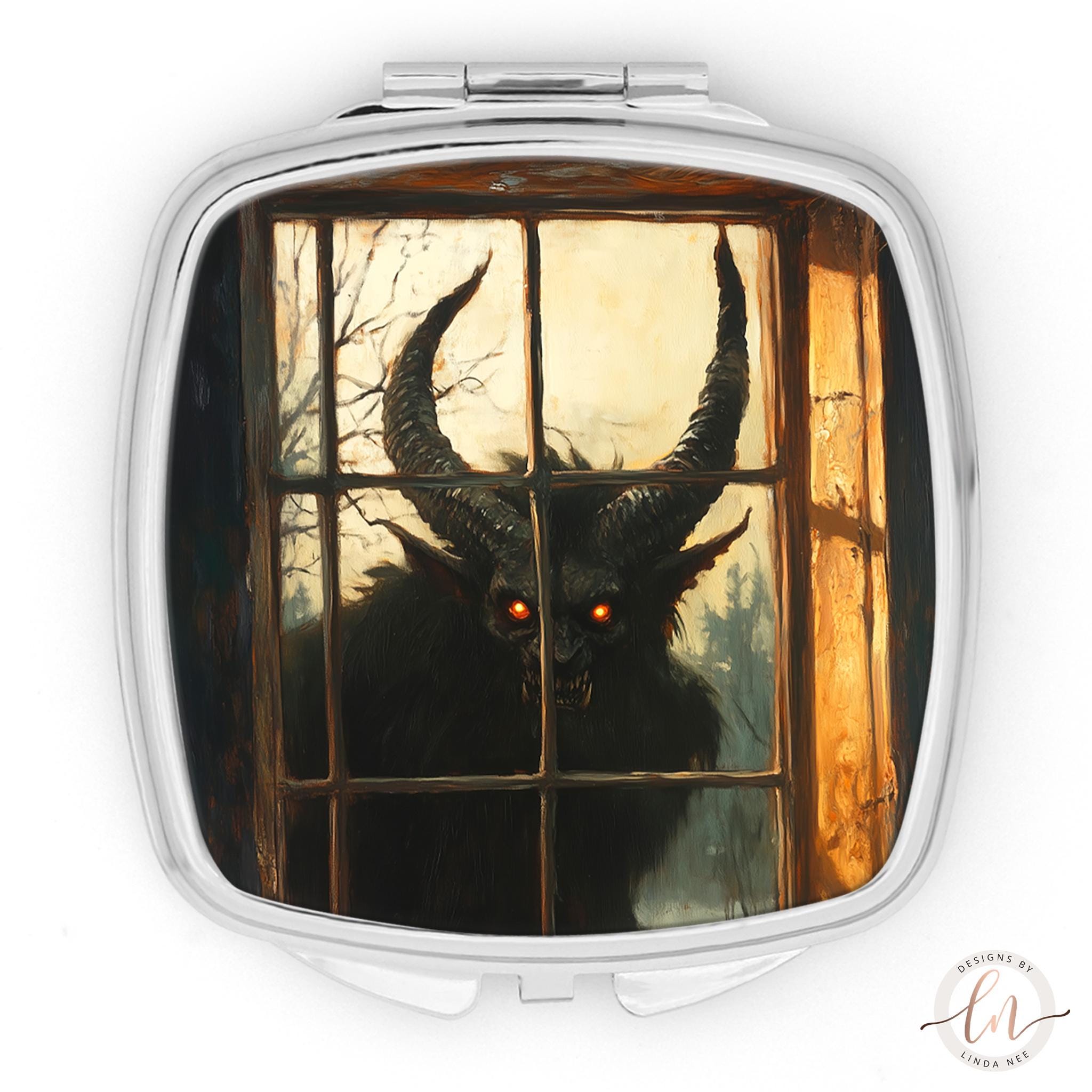 A square mirror with a painting of a horned, glowing creature peering through a window.