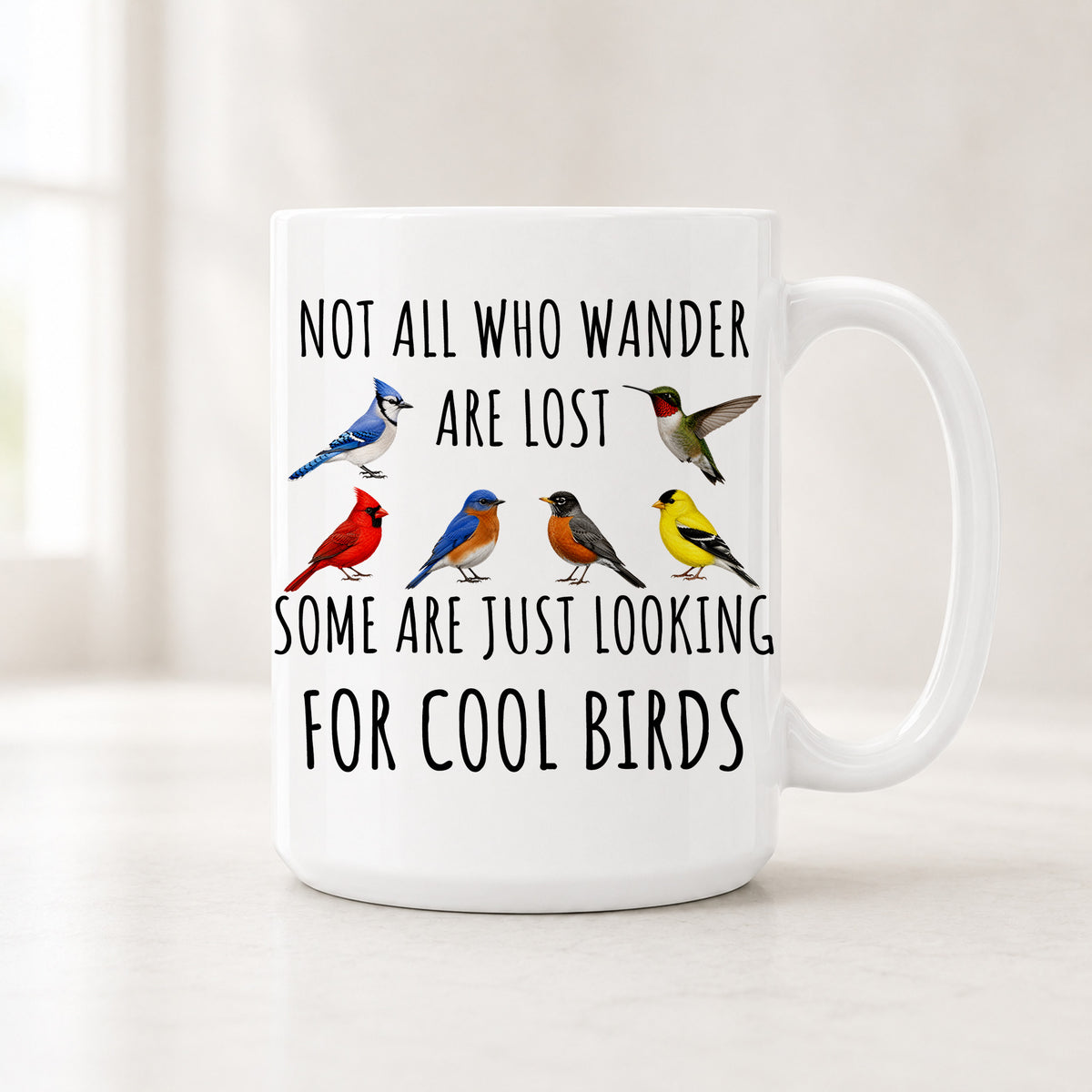 15 oz backyard bird mug with a blue jay, hummingbird, cardinal, bluebird, robin and goldfinch between lines of text