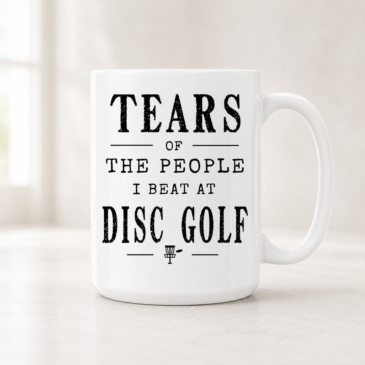 15 oz Tears of the People I Beat at Disc Golf mug with bold black vintage lettering and a small themed icon