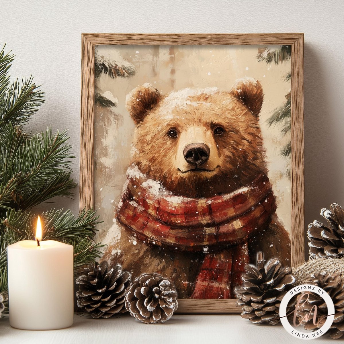 A framed painting of a brown bear wearing a red and white plaid scarf, surrounded by pine cones and a lit candle, creating a cozy winter scene.