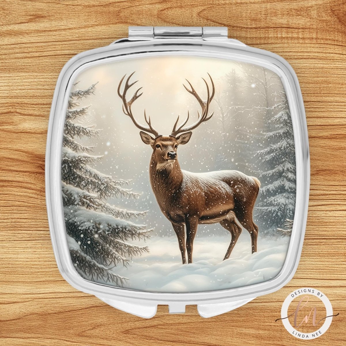 A deer standing in a snowy forest with snowflakes falling around it.