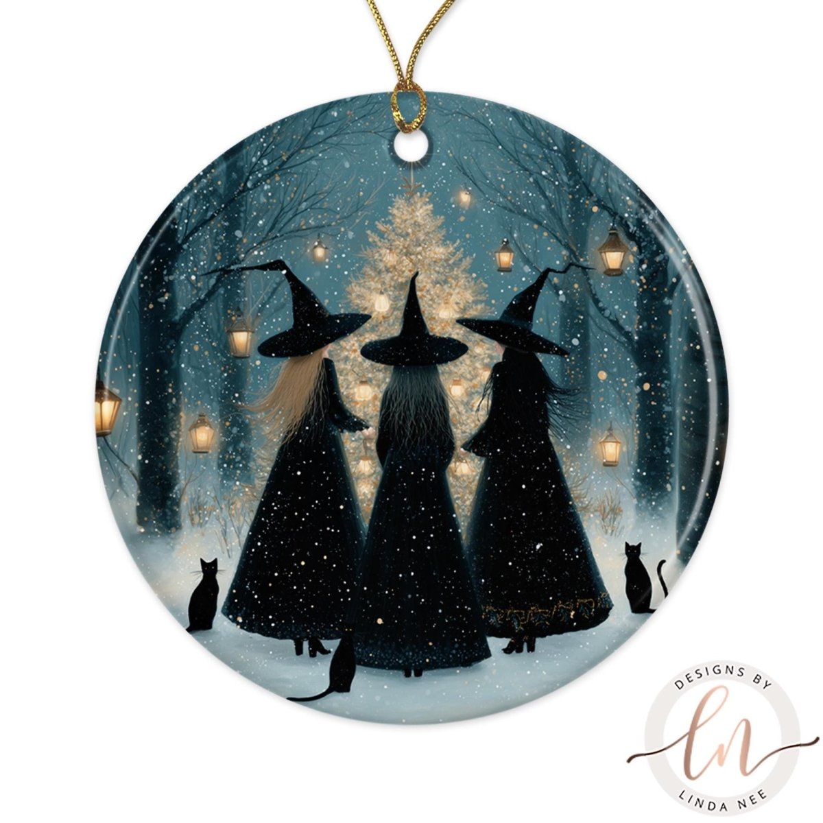 A round ornament featuring three black-haired women wearing black dresses and black hats, standing in a snowy forest with a Christmas tree in the background.