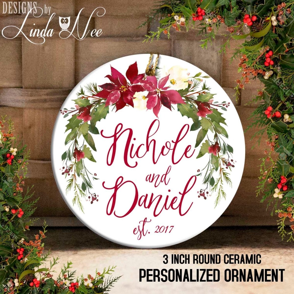 Round ceramic personalized ornament with floral design and text, surrounded by Christmas decorations.