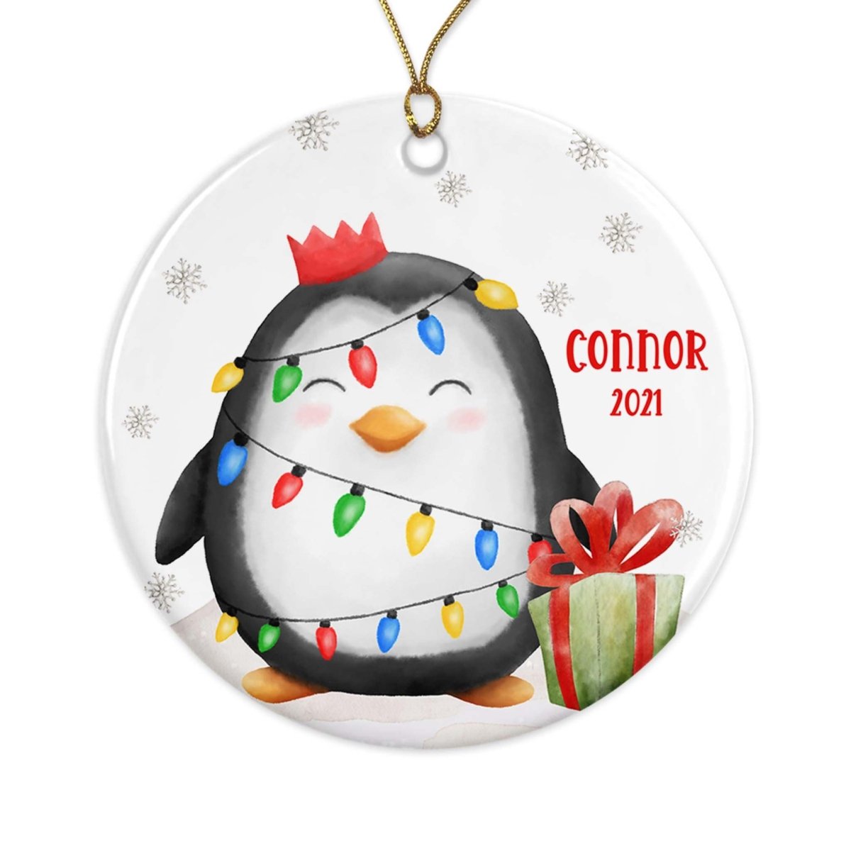 Christmas ornament with a penguin decorated with lights and a gift, featuring the name 'Connor' and the year '2021'.