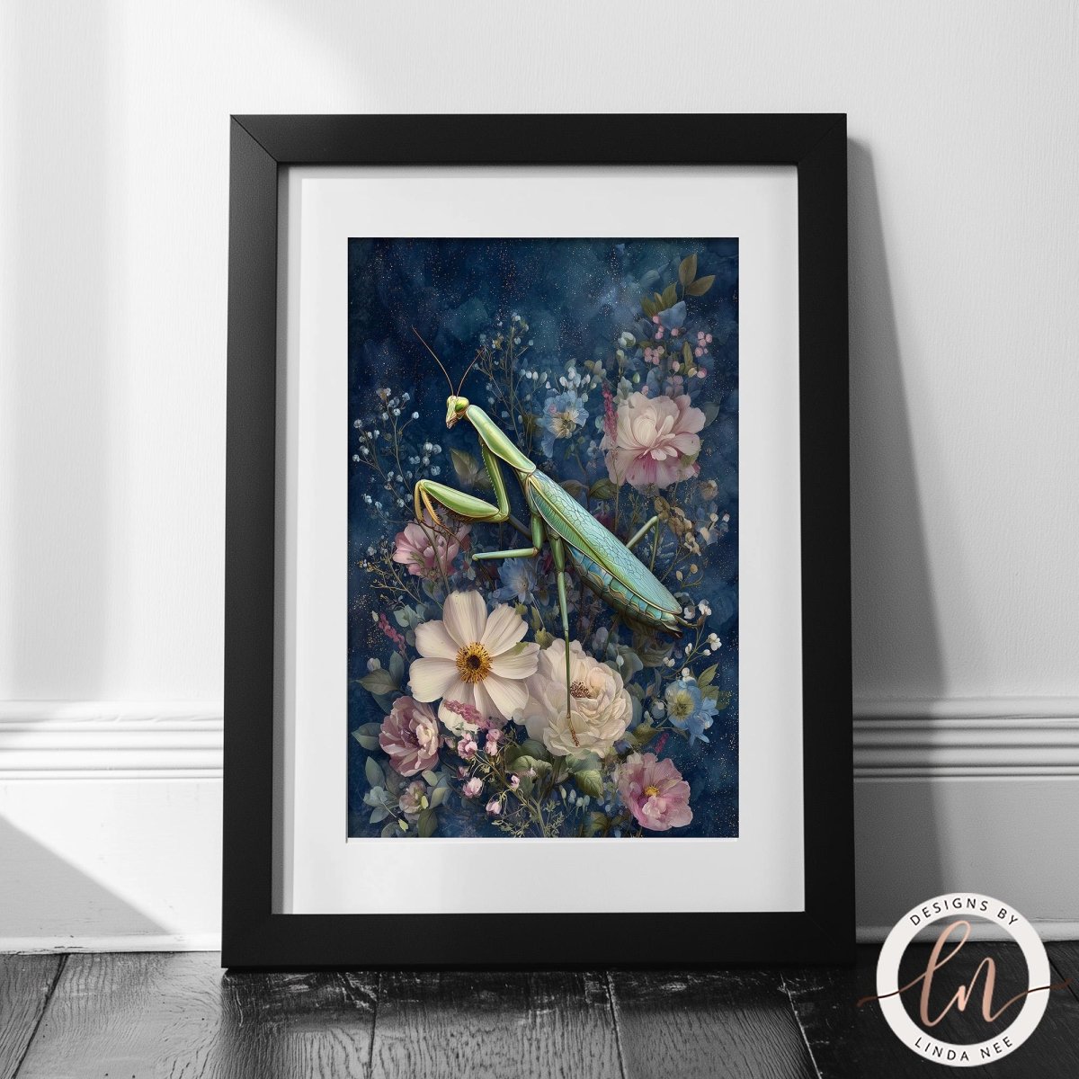 A framed print depicting a praying mantis surrounded by a vibrant floral arrangement, including pink and white flowers, against a dark blue background.