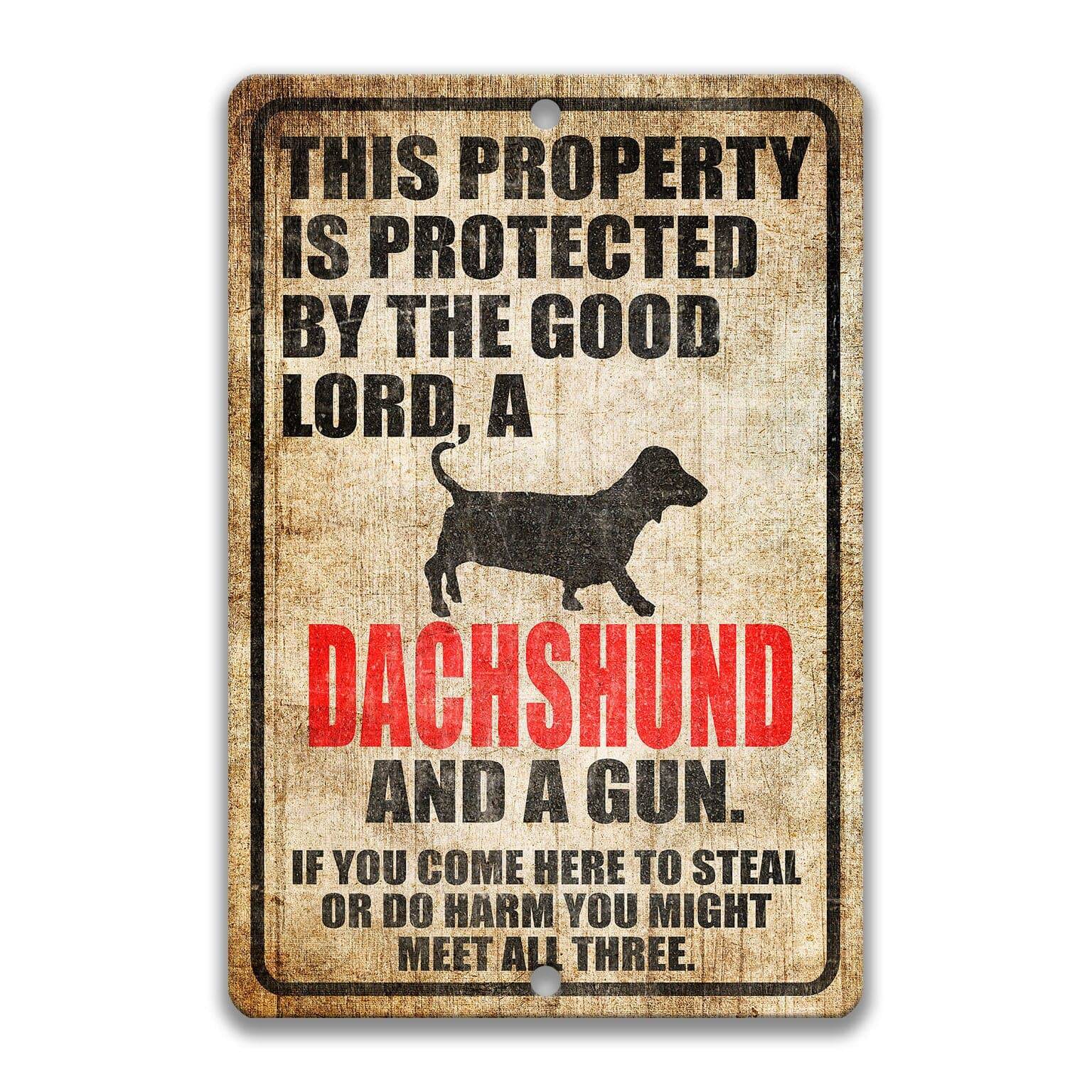 Property Protected by the Good Lord, a Dachshund, and a Gun Dog Sign