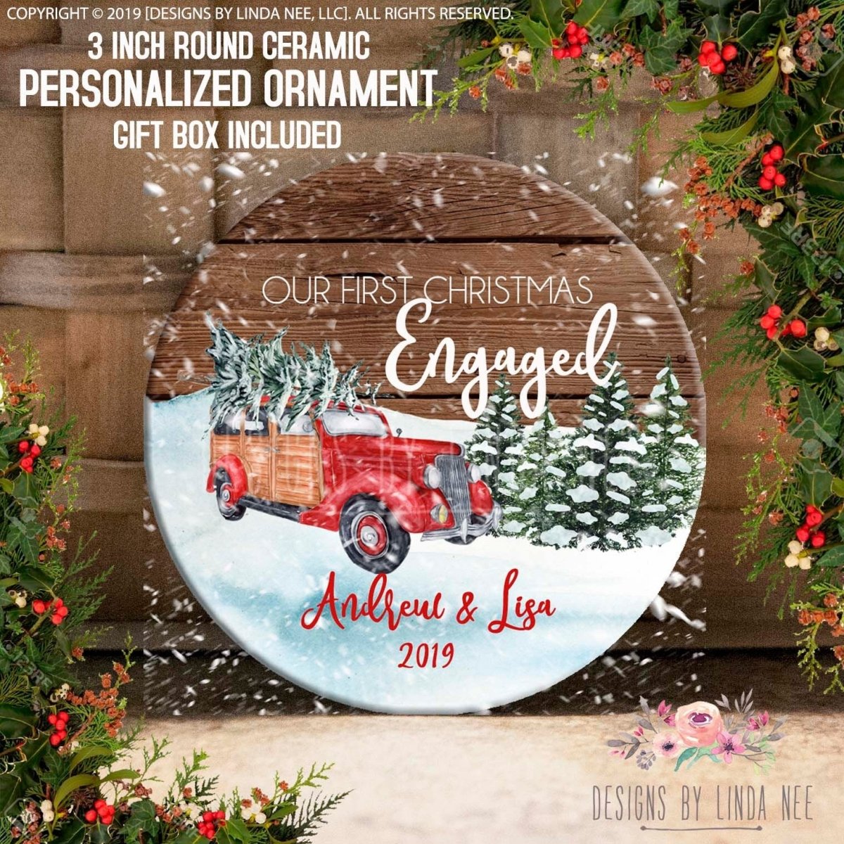 The image is a circular decorative piece featuring a red truck carrying a Christmas tree, surrounded by snow and greenery. The text on the piece reads "Our first Christmas Engaged Andrew & Lisa 2019", indicating that it is a personalized ornament for a couple who are engaged.