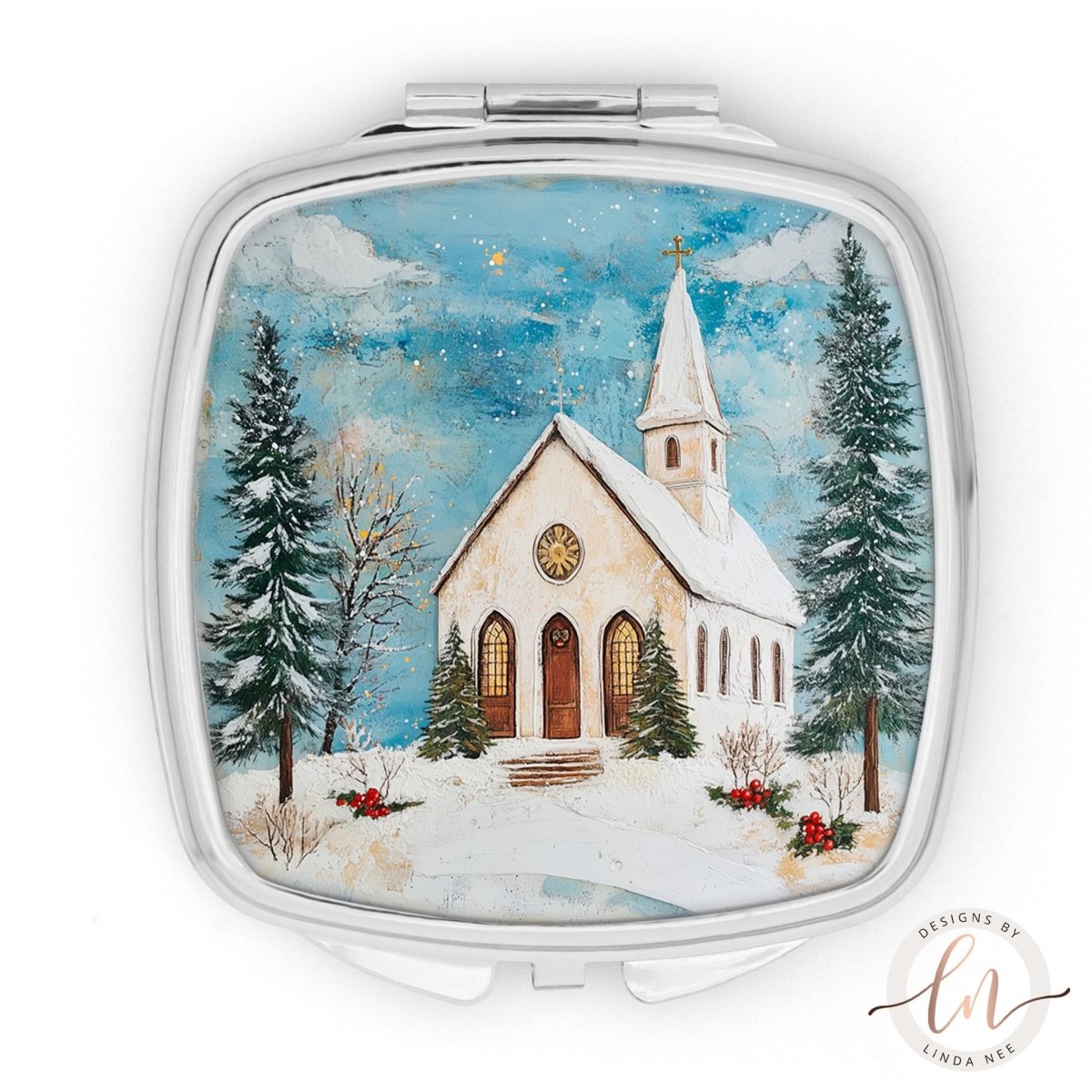 A square-shaped compact mirror with a winter scene of a church surrounded by snow-covered trees and a starry sky.
