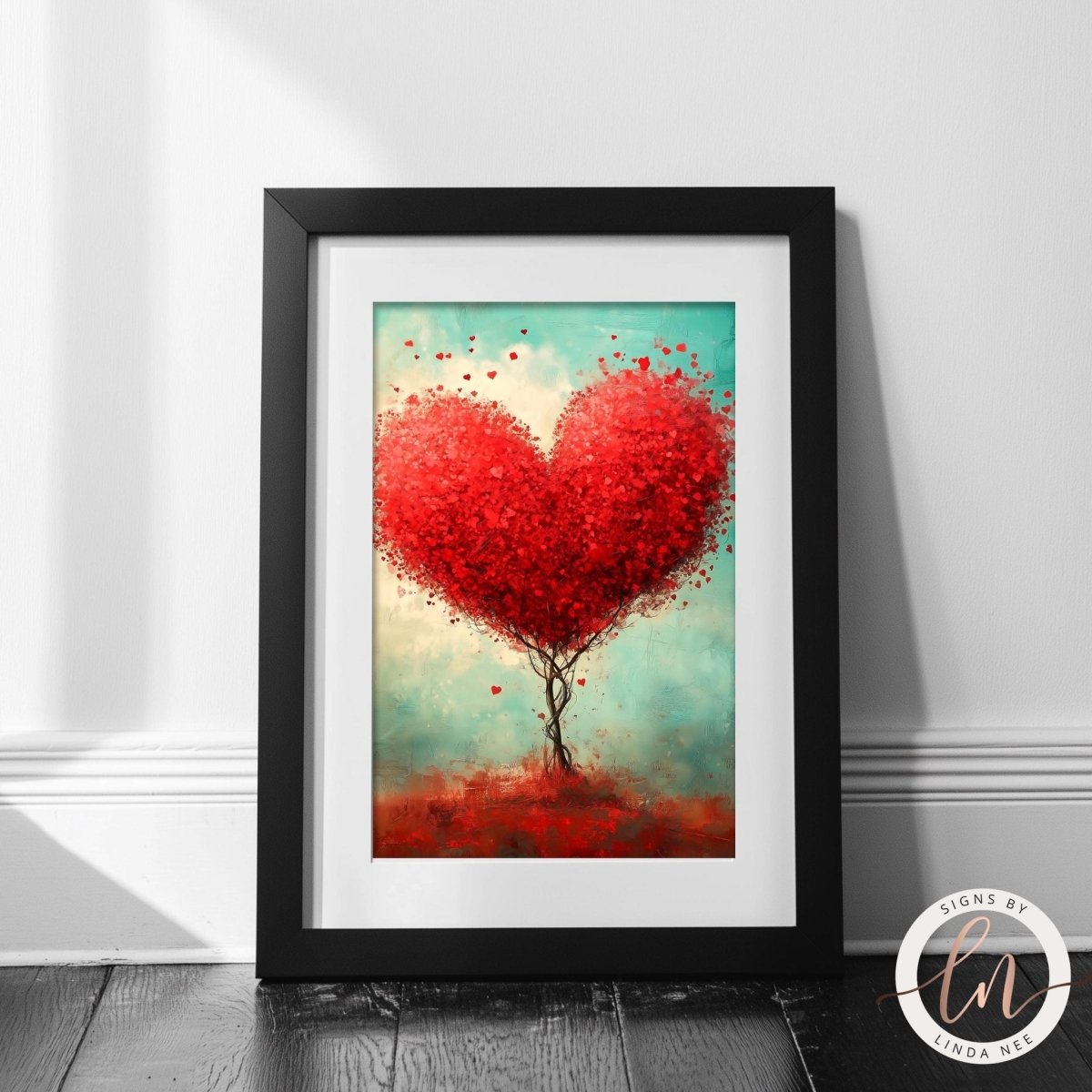 A framed painting depicting a heart-shaped tree with red leaves, set against a light blue background.