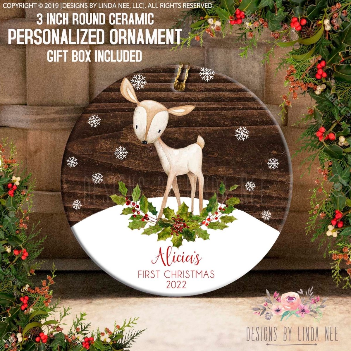 a ceramic ornament with a deer and snowflakes, surrounded by a wreath of berries and greenery. The ornament is personalized and includes a gift box.