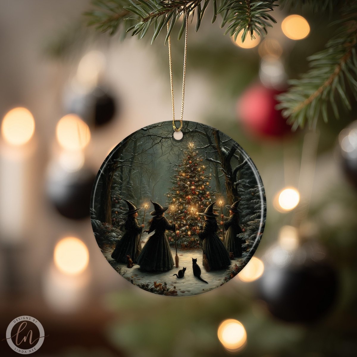 A round ornament hanging from a tree, depicting a scene with four women in black dresses and three cats, with a lit Christmas tree in the background.